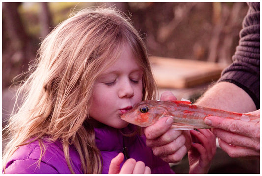 girl kissing fish