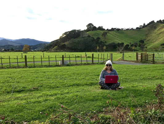 lady working on laptop in countryside